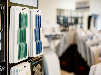 Display of decorative tiles in shades of green and blue, with more tiles visible in the background.